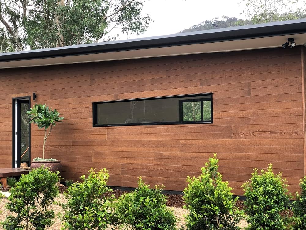 Low-maintenance exterior cladding panel installation showcasing weather-resistant wood finish and stone textures on a modern residential facade.