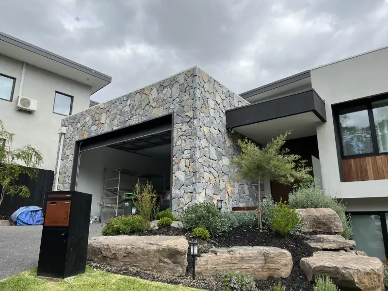 Modern building exterior featuring durable stone cladding for a natural and elegant facade finish.